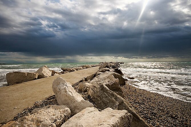 Lido Bike Tour: With a Local on the Island of Cinema - Murazzi Free beach and the sea wall engineering you can ride beside