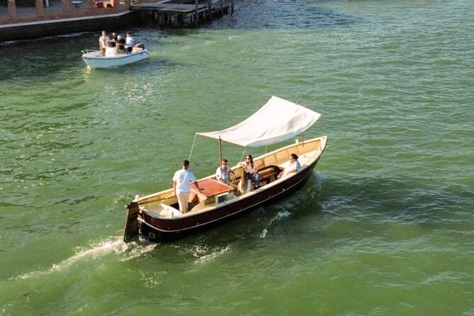 Sunset in a typical boat in Venice - Approaching Piazza San Marco by lagoon: domes, mosaics, and the approach feeling