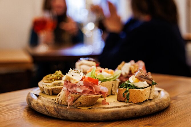 Venice Evening Food Tour: Bites, Drinks & Sit-Down Dinner - Stop 1 at a traditional bacaro: meat cicchetti and a Select Spritz